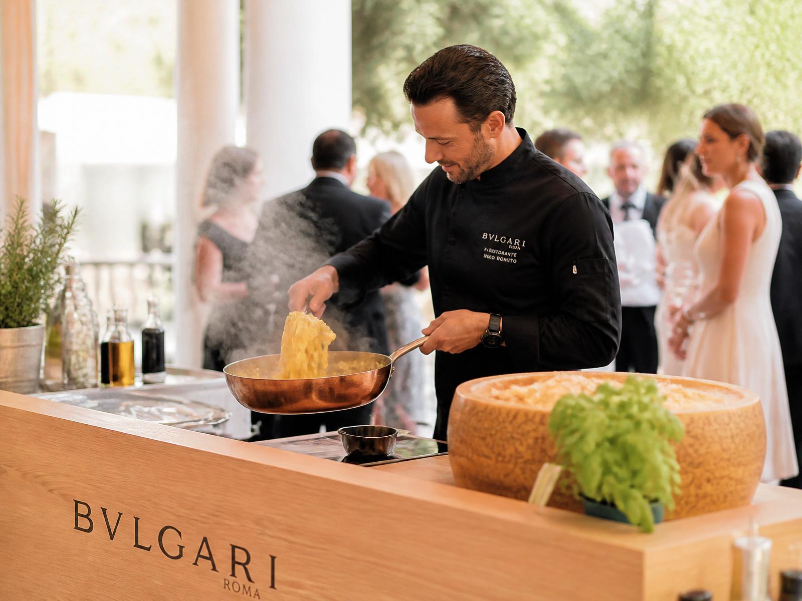 Chef finishing fresh pasta for guests